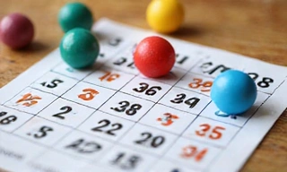 Bingo card with dabbed numbers and bingo balls