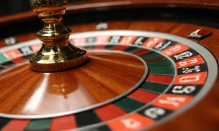 Roulette wheel with ball landing on a number